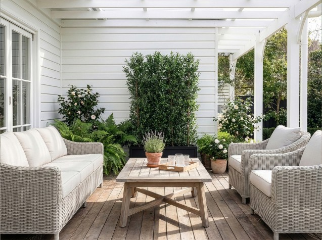 Artificial olive hedge with realistic green foliage and UVSilx protection, ideal for creating easy care screening and greenery in sun exposed spaces.